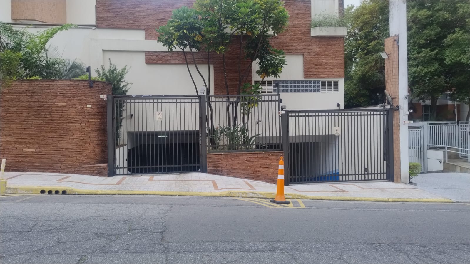 Portões automáticos de grade metálica na entrada de garagem de edifício